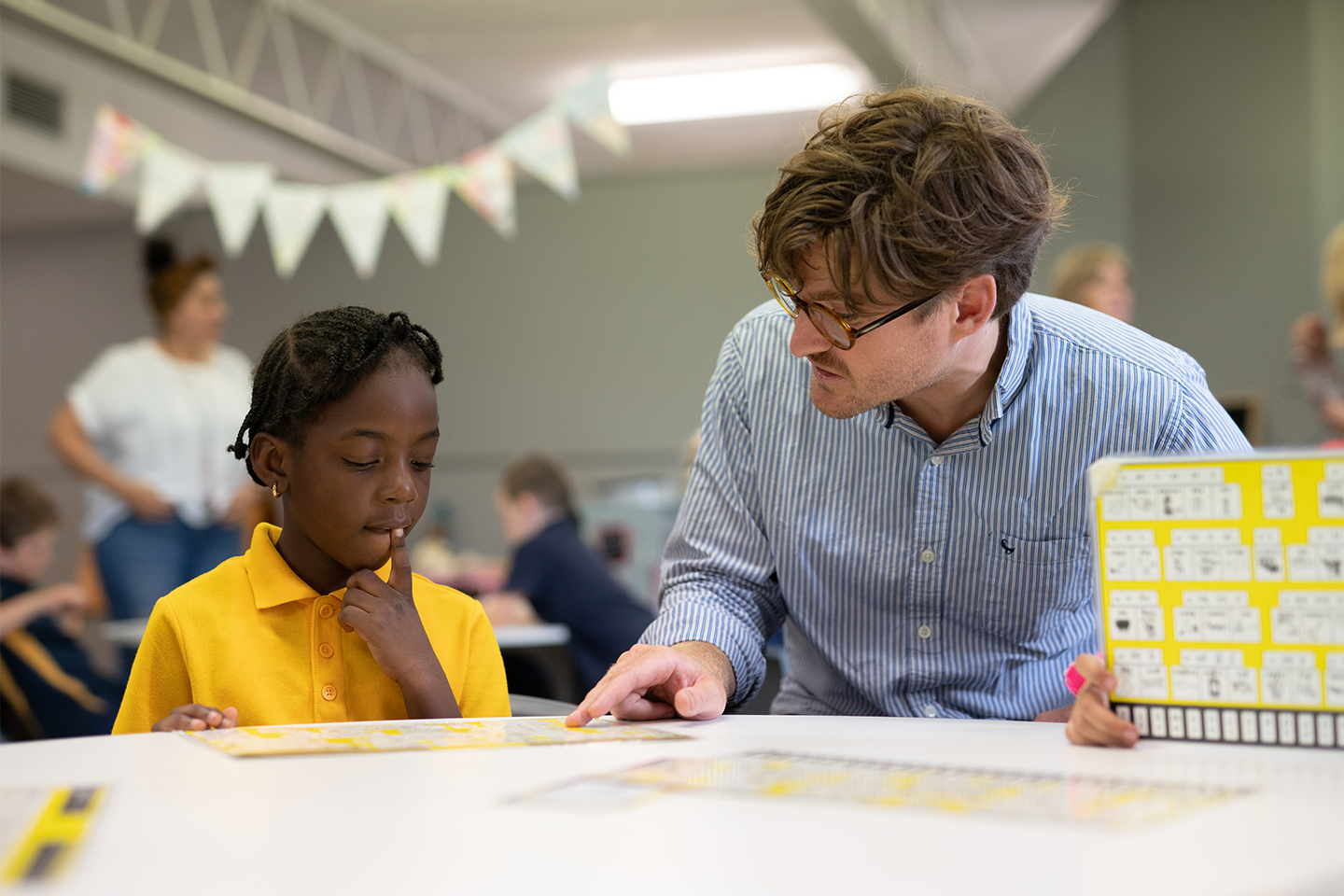 Photo of teacher and student working through a math task in classroom