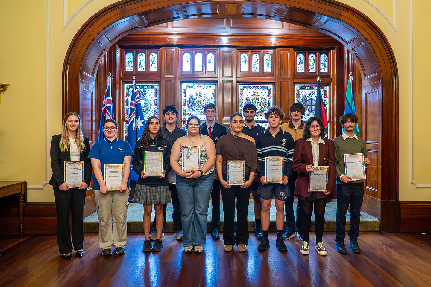 Group photo of students with scholarship and award certificates