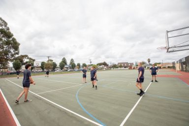 High school students playing basketball