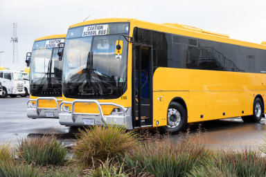 Photo of two large yellow school buses parked side-by-side