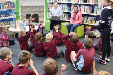 Photo of Lenswood Primary School students in class raising their hands