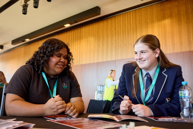 Two students sitting at a table at the Active Citizenship Convention