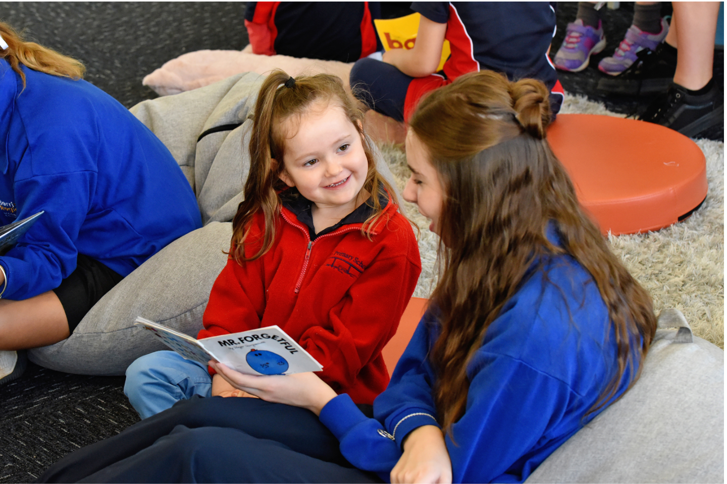 Two students, one older and one younger reading 