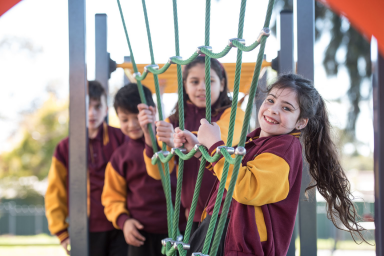 students, on playground, playing and smiling 