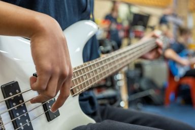 Student playing guitar 