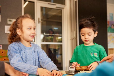 Photo of two preschoolers making scones at preschool