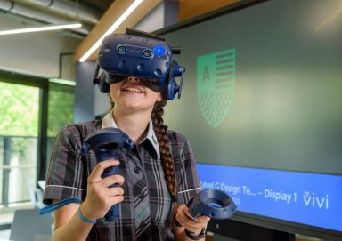 A student, with immersive technology on 