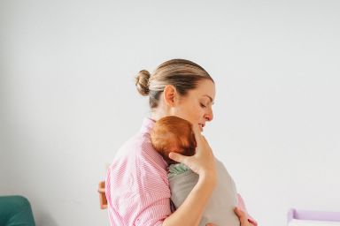 A mother holding a baby 