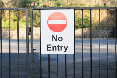 Photo of school fence with sign saying, 'No entry'