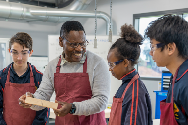 Photo of Design and Technology teacher teaching a group of students