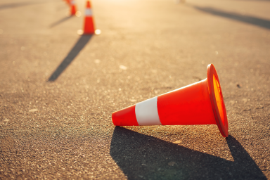 Photo of traffic cones on road with one cone knocked over
