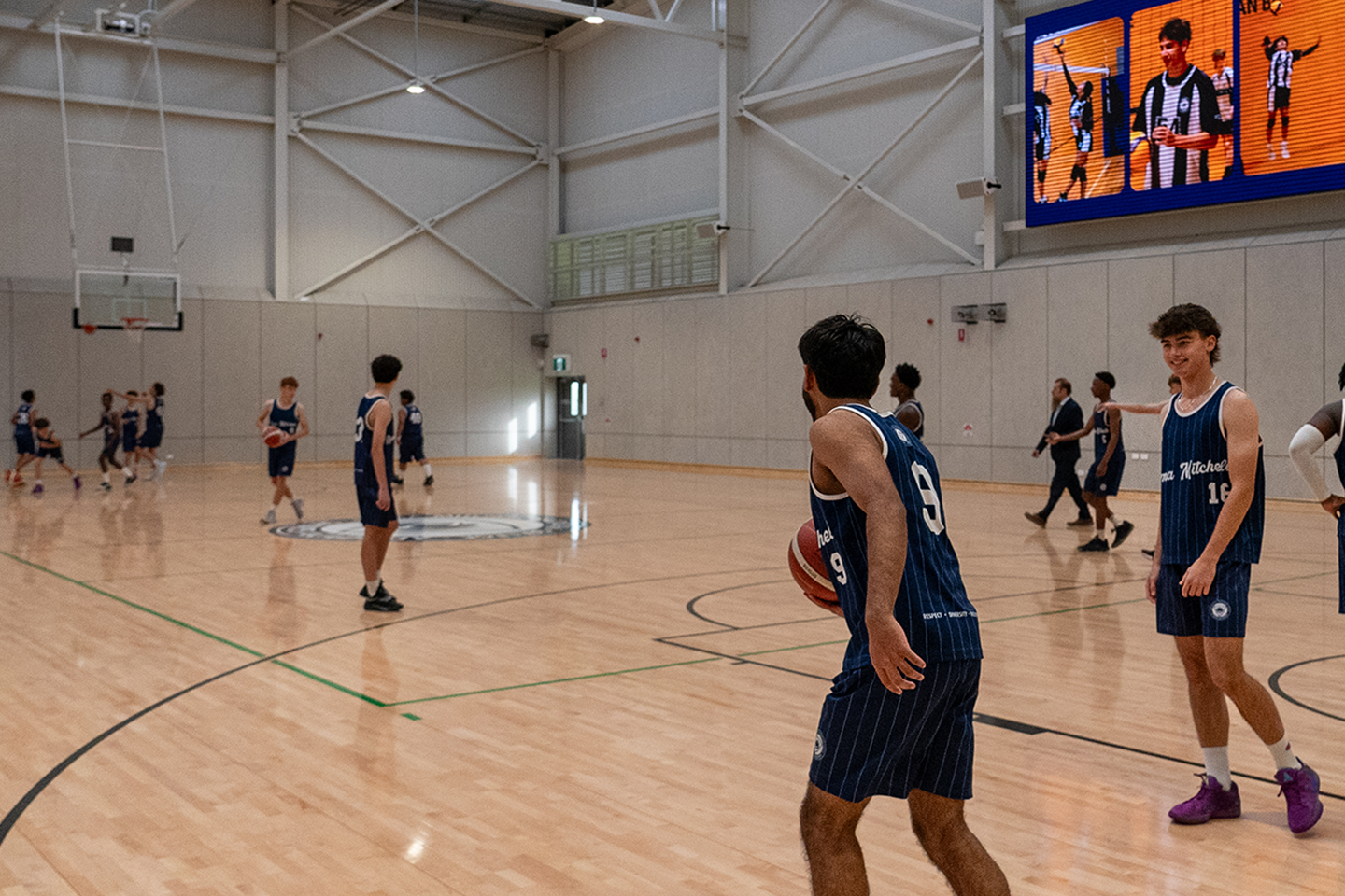 Photo of Roma Mitchell Secondary College students playing basketball in new gymnasium