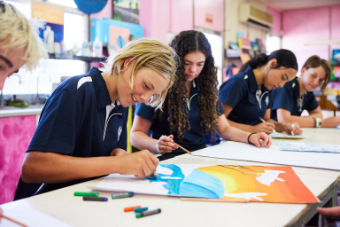 Photo of secondary school students painting in classroom