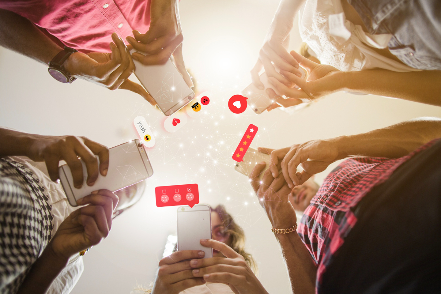 Photo of people using phones with social media icons and reactions coming off the phones