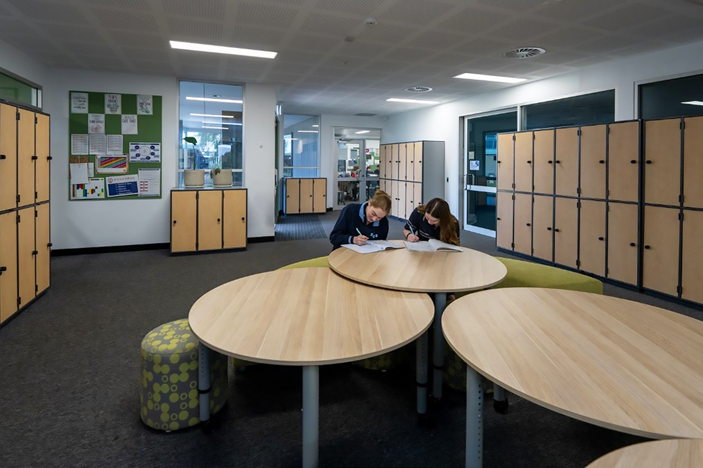 Photo of collaborative learning space with students sitting at a table at Kingston Community School