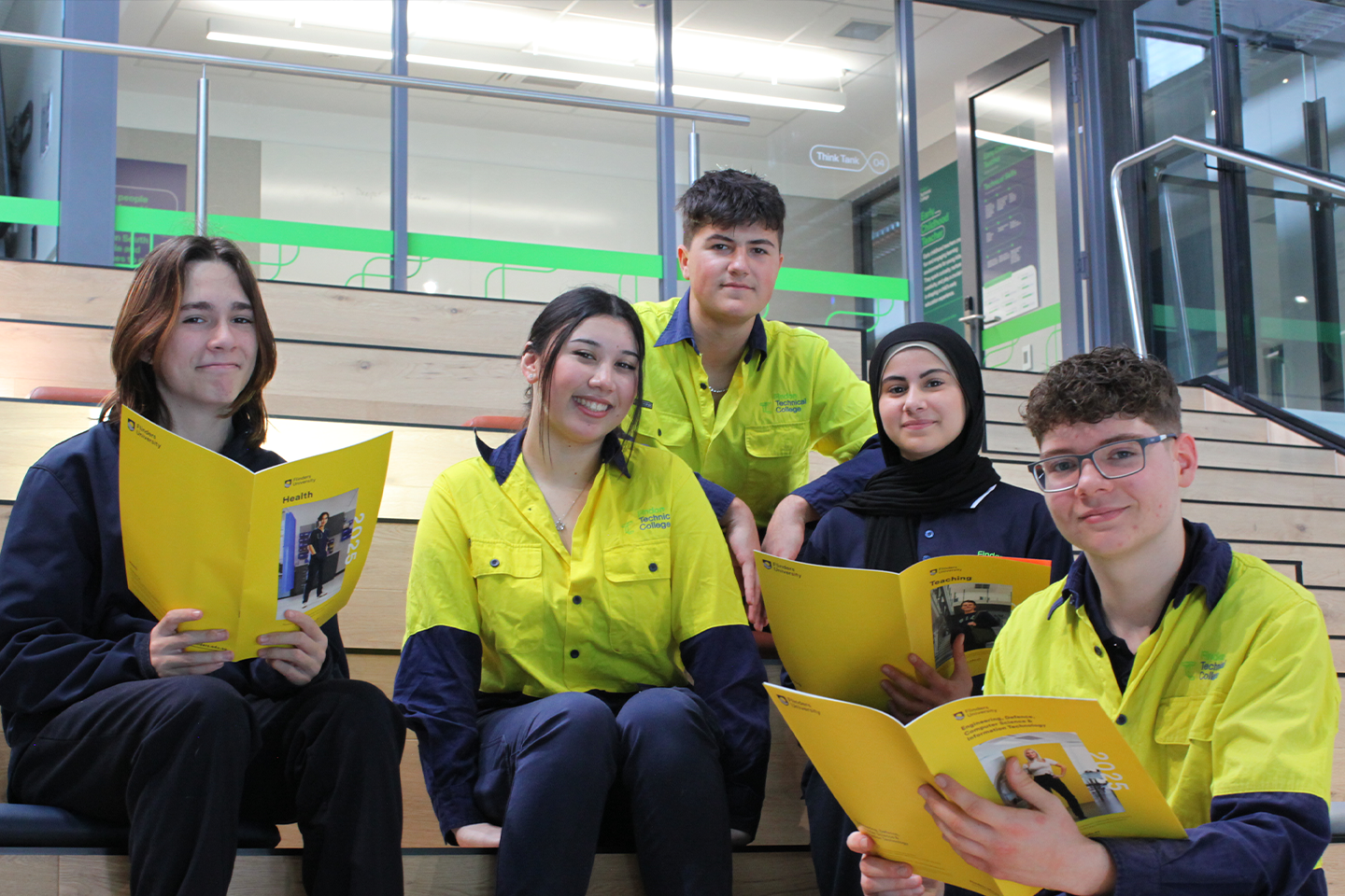 Photo of a group of Findon Technical College students sitting down with Flinders University information booklets