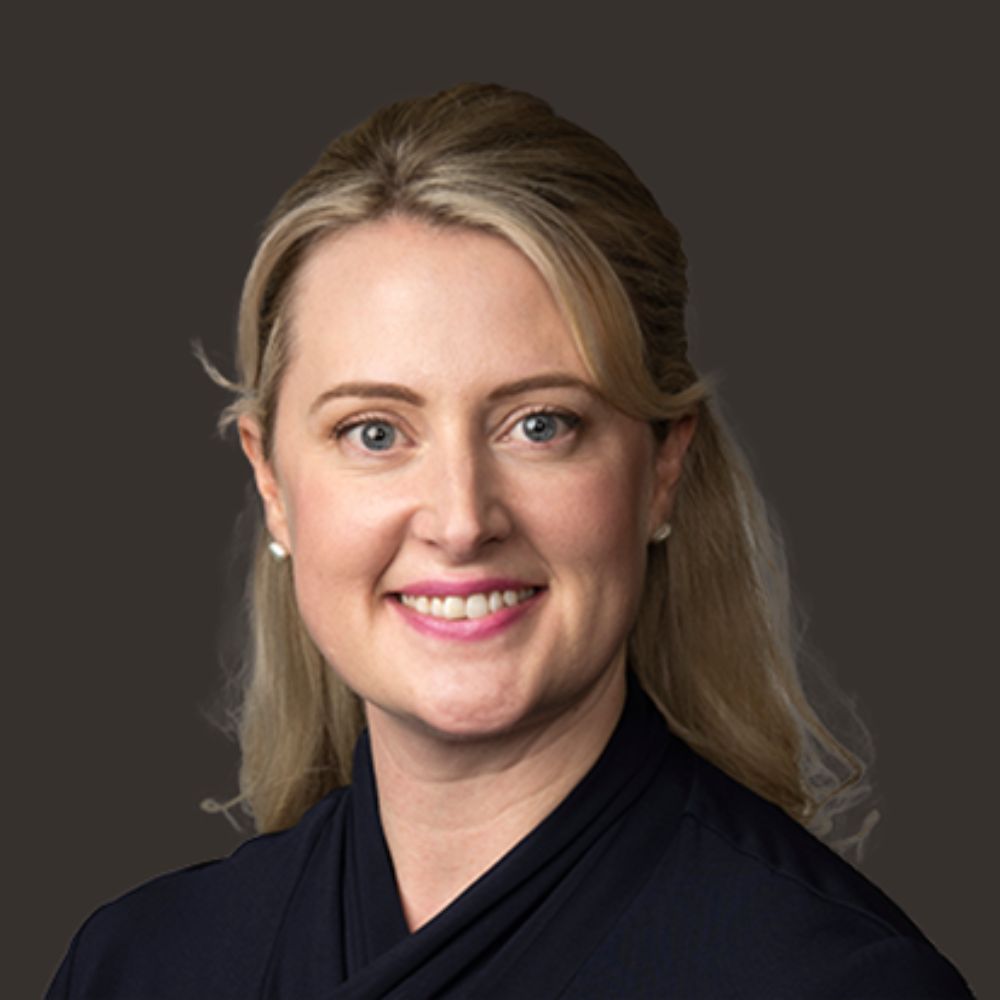 Headshot of Lucy Hood, smiling and wearing a top