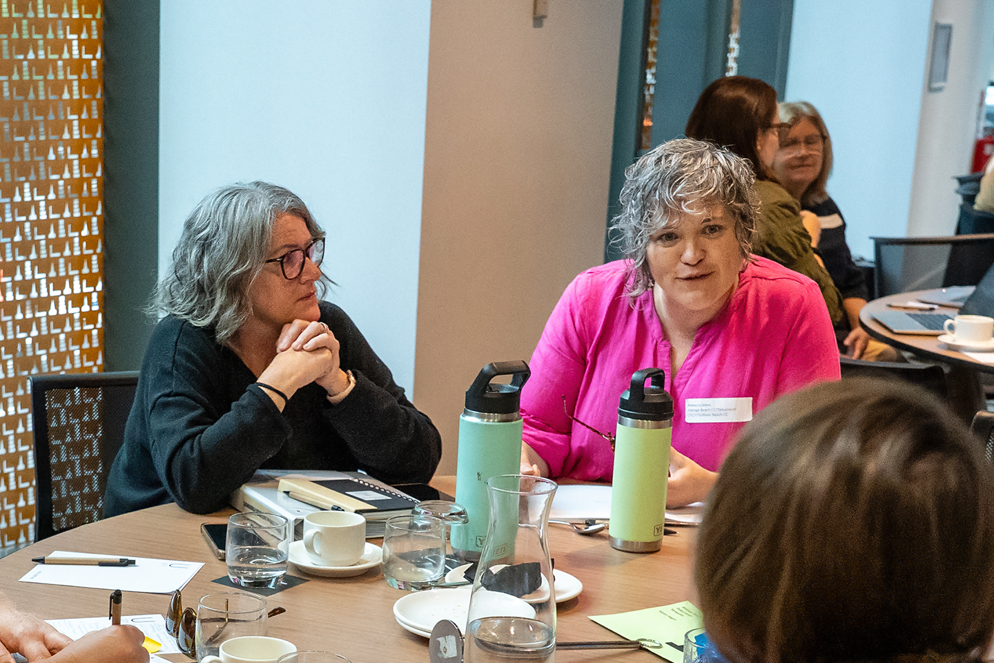 Photo of two early childhood educators around a table at a conference