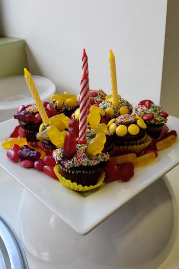Birthday cupcakes decorated with candles and lollies