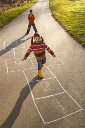 Two girls playing hopscotch