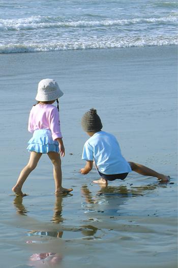 Two children playing in the sand