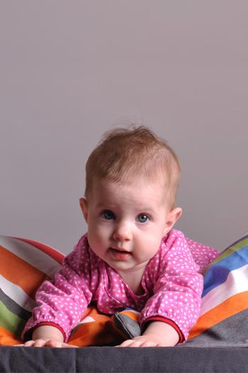 Baby girl lying on a pillow