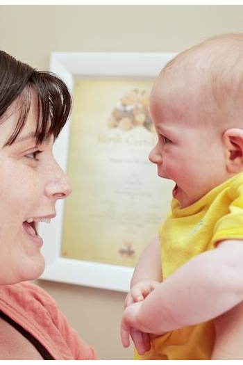 Mother holding baby up level with her face