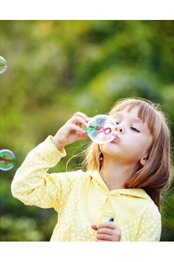 Young girl blowing bubbles