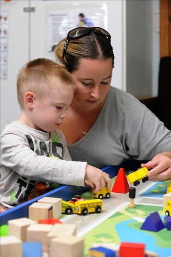 Mother and son playing with toys