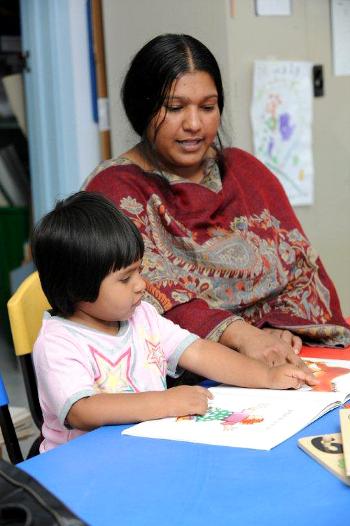 Woman siting at a table with a child