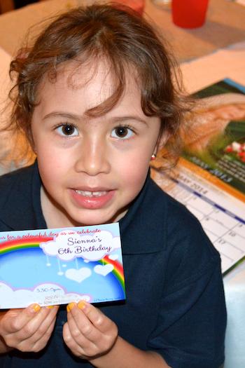 Young girl holding up a calendar she made