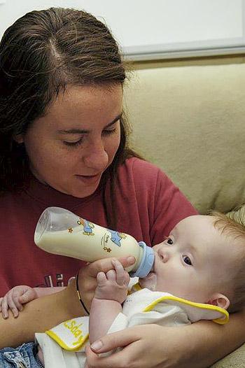 Woman feeding baby from a bottle