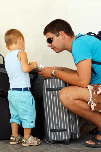 Father and son packing to go on holidays 