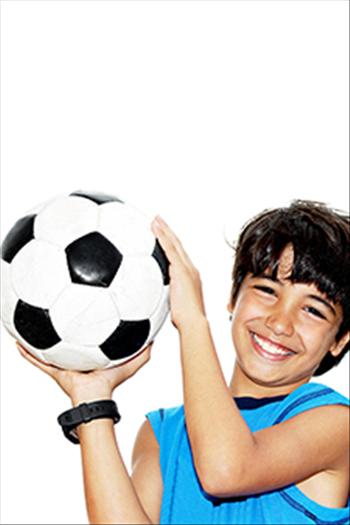 Boy aged between 5-10 years old holding a soccer ball