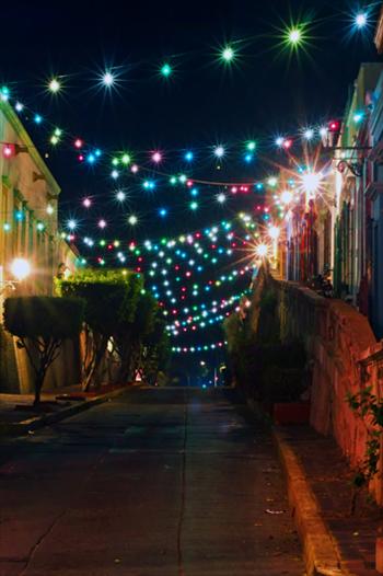 Street lit up by small coloured lights