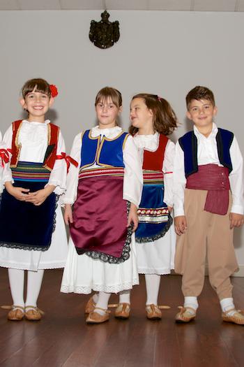 Four children in festive clothes