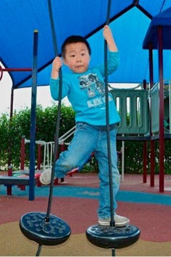 Child climbing on playground equipment