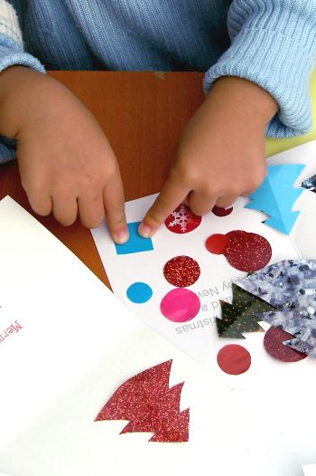 Child making a Christmas card