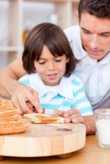 Father and son making toast together