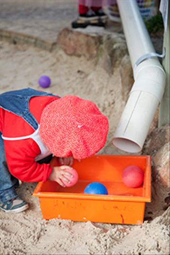 Young girl playing with balls