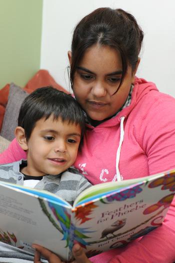 Woman reading to a boy