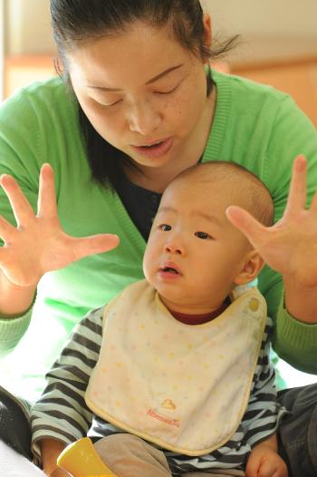 Mother singing with her baby in her lap