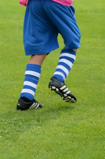 Child running in soccer gear