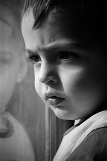 Young boy looking out a window