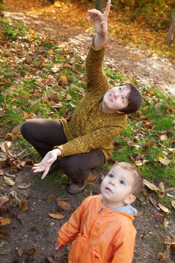 Woman and boy pointing up at the sky