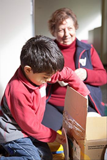 Young buy building a car out of cardboard