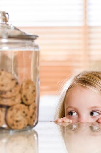 Young girl looking at a cookie jar