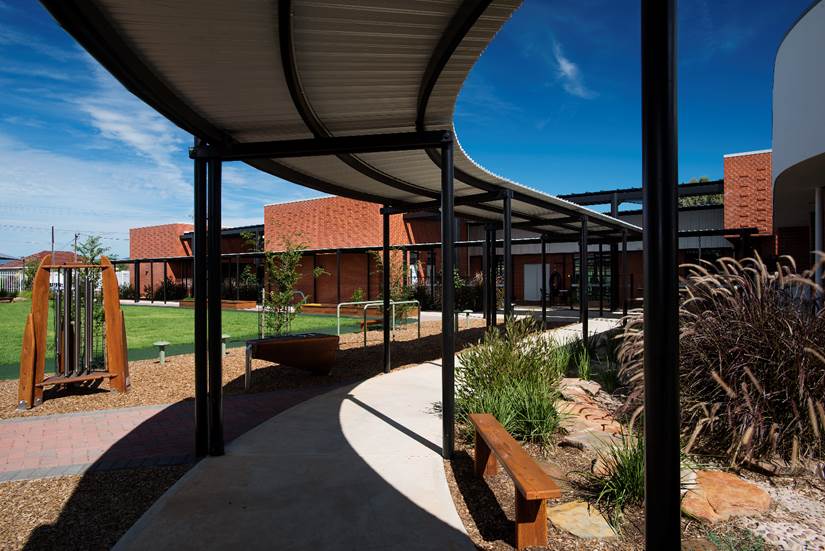 A clear path through different terrains leading to a building. Photo.