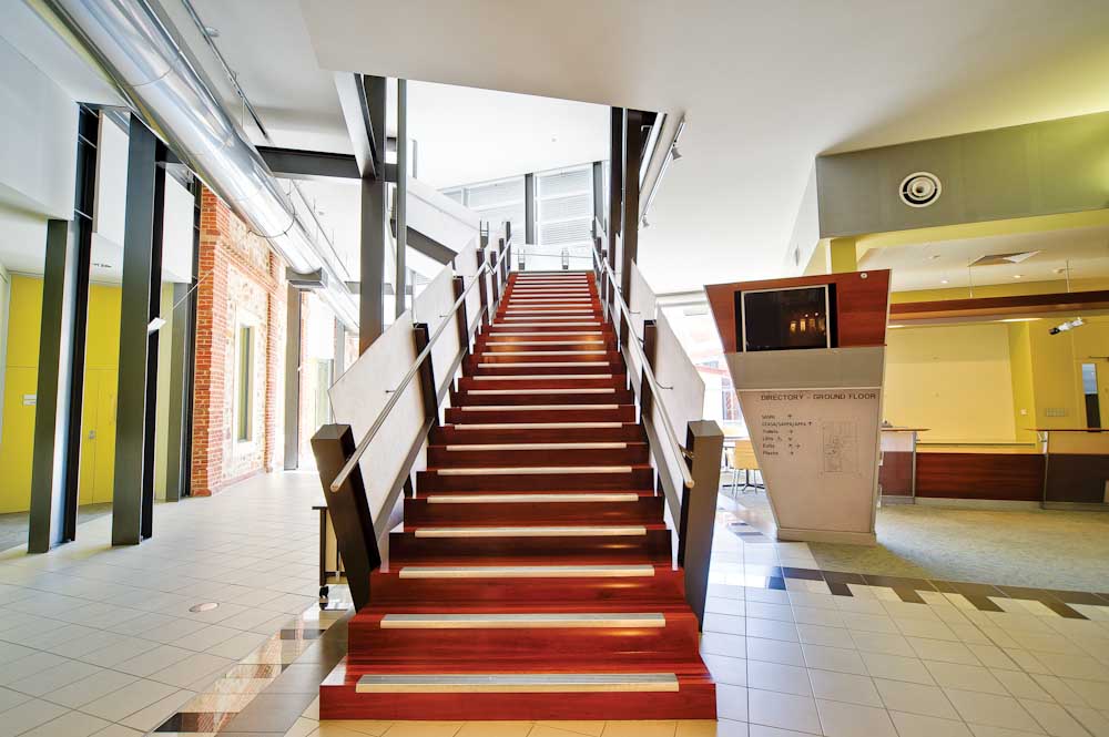 Education Development Centre redwood staircase and ground floor directory.