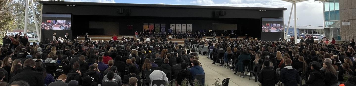 Students sitting under the pavilion at the official opening of the facility upgrade at Gawler and District College B-12